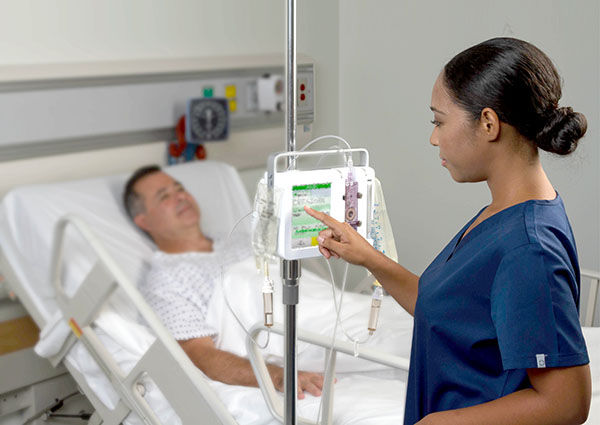 woman using ivenix infusion system in hospital